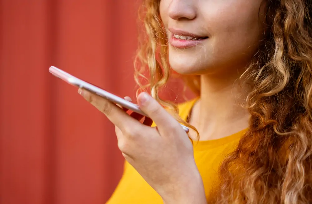 woman doing voice search on mobile phone