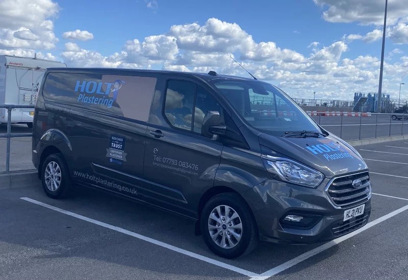 A company branded van of holt plastering 