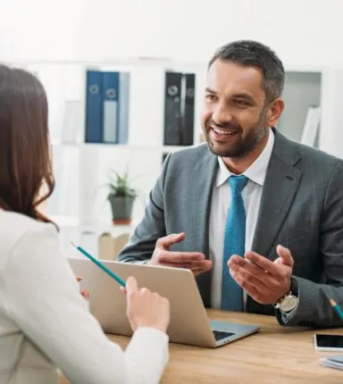 happy businessman chatting to a lady in an office